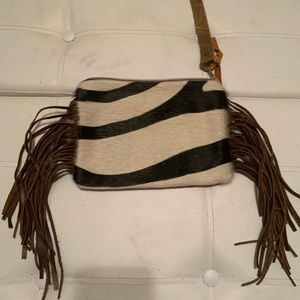Cowhide wristlet. Black/white fur, tapestry back.